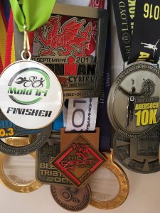 selection of finisher medals from 2017 triathlon season